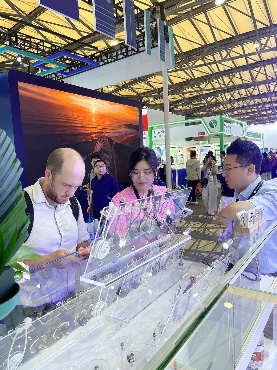 CTP team discussing magnetic connector requirements with an exhibition visitor