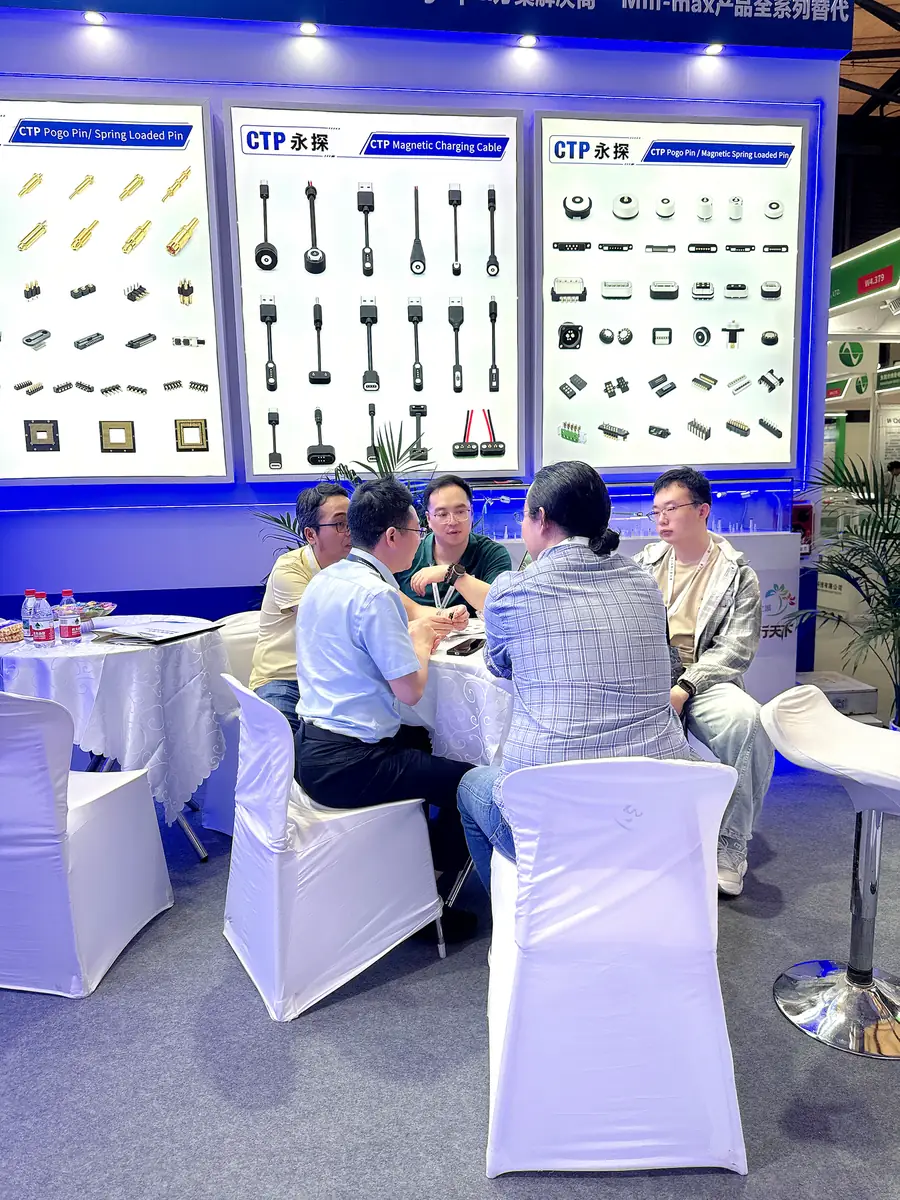 Engineering discussion at the CTP booth with magnetic connector and cable displays