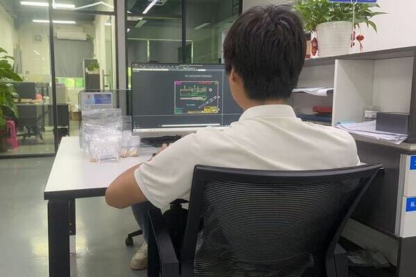 Engineer reviewing a custom magnetic pogo pin design on a computer